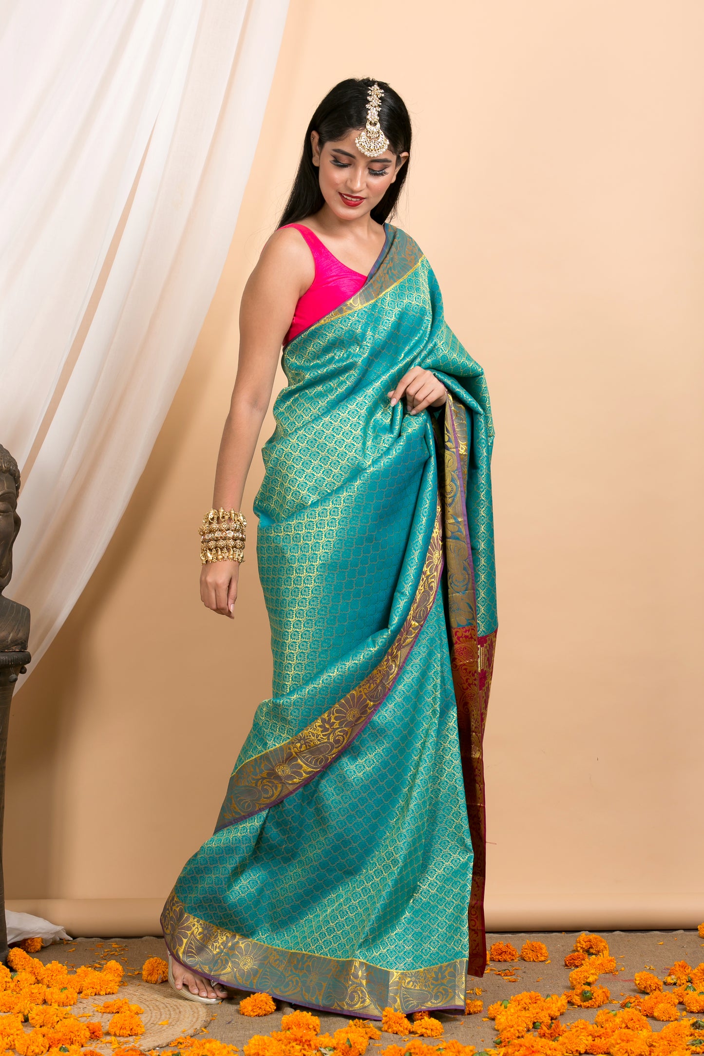 Blue Kanjivaram saree with Gold Floral zari Border and red palla