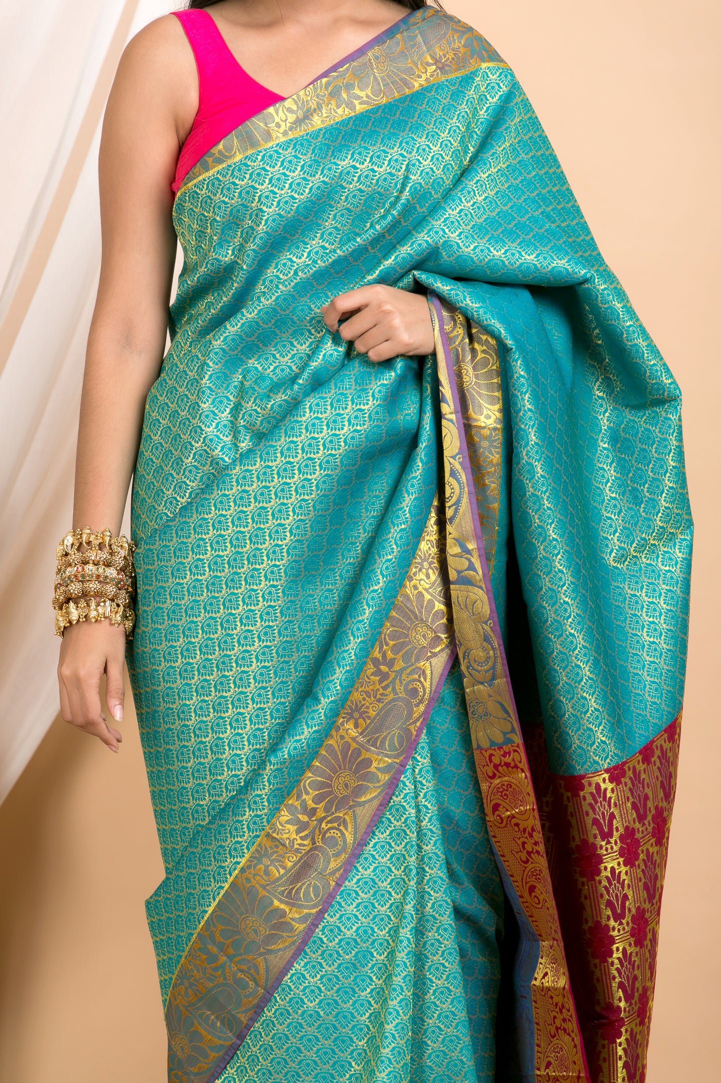 Blue Kanjivaram saree with Gold Floral zari Border and red palla